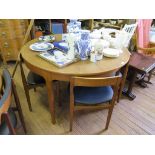 A Nathan teak extending dining table and four dining chairs, 122cm wide