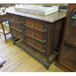 A 1930's oak chest of drawers, with two short and two long panelled drawers on barleytwist legs