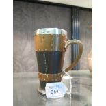 A Doulton Silicon leather effect tankard with silver mounted rim, stamped 9962 13.5cm high