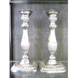 A pair of silver candlesticks with shell and fluted decoration, 26cm high, Birmingham 1948