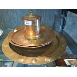 An Arts and Crafts style copper charger 38cm diameter, two other copper dishes, a copper and brass