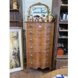 A shaped walnut tallboy, with hinged shaped mirror over six drawers, 61cm wide 166cm high