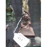 A 19th century bronze figure of Ho Tai, the arms raised, on stepped square base, 7.5cm high