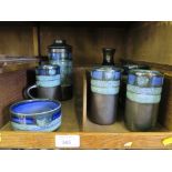 An art pottery six piece coffee set and matching vase with an attractive sgraffito design and blue