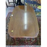 A 1960's teak coffee table, of rounded rectangular form with undershelf and turned legs 92cm x 55cm