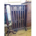 An oak revolving bookcase, with gadrooned edge and cross frame base 52cm x 54cm x 105cm high