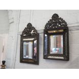 A Dutch pressed brass wall mirror with cushioned bevelled plate, 60cm x 33cm and another similar (