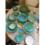 Various green majolica plates and dishes, including Wedgwood and Portuguese