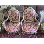 A pair of Louis XV style giltwood armchairs, the carved oval backs with red upholstery on turned