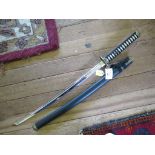 A reproduction Samurai sword, with white shagreen handle, leather scabbard and brass tsuba 91cm