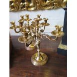 A pair of five light brass candlesticks with scroll arms and circular foot, 29cm high