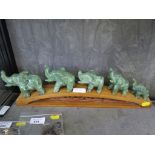 A jade figure group of a five elephant family on a bridge