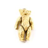 A gold colour articulated teddy bear