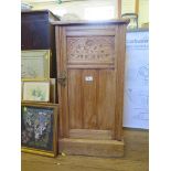 An Edwardian oak bedside cupboard, with floral carved panelled door and raised back 41cm wide