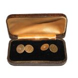 A pair of 14 carat gold cufflinks, engine turned decoration with a single diamond to the centre of