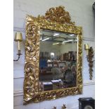 An Italian 18th century style Florentine giltwood wall mirror, scrolling acanthus carved cushion