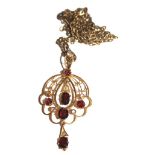 An Edwardian 15 carat gold pendant set with garnets and rose diamonds on 9 carat neck chain