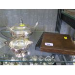 A silver plated tea pot and cream jug, two boxes of tea knives and cake forks