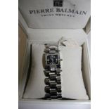 A Pierre Balmain watch, stainless steel, with stone set shoulders and black dial, boxed