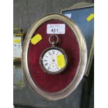 A continental silver pocket watch, marked 935, 5cm diameter and an oval silver photo frame 8cm high