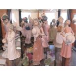 Three Lladro figures of Japanese girls holding fans, two figures of girls holding hats, another of a