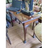 A George III mahogany side table, possibly Irish, the moulded rectangular top over a scroll and