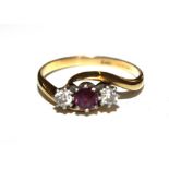 A three stone ruby and diamond ring set in 19 carat gold