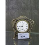 A silver cased bedside clock with brightcut decoration to case