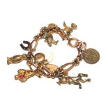 A 9 carat gold charm bracelet having some fourteen charms, not all gold