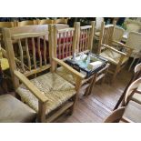 A set of four rustic style ash dining chairs, with rail backs and rush seats, including two carvers