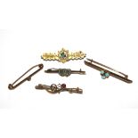 A collection of gold and gem set brooches