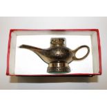 A table lighter in the form of a genie's lamp, boxed, 20cm long