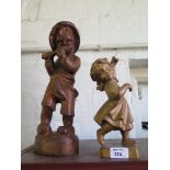 A German carved sculptured model of a young girl dancing, 24cm high and a boy playing a flute
