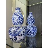 A pair of Chinese blue and white double gourd form vases, decorated with chrysanthemums and exotic