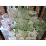 A variety of glassware, including green glass vases, jugs, bowls, cakestands and bottles