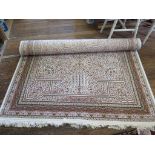 A Persian silk rug, the ivory ground with central medallion and allover floral design within a