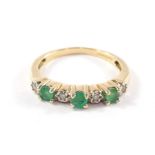 A seven stone emerald and diamond ring