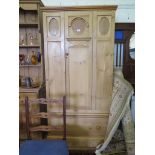 A small pine wardrobe, the central panelled door and sides over a long drawer on bracket feet,