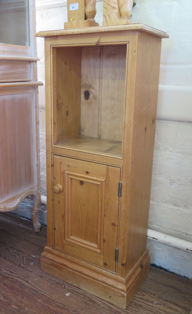 A small pine cabinet, with recessed opening over a cupboard door and plinth base, 43cm wide, 104cm