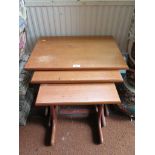 A teak nest of three tables 56cm wide