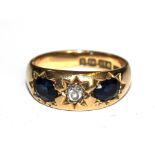 A heavy 18 carat gold sapphire and diamond three stone ring set in 18 carat gold