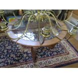 A 1970s G-Plan Astro teak coffee table, the circular glass inset top on downswept supports, 84cm