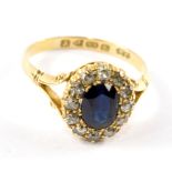 A sapphire and diamond cluster ring set in 18 carat gold