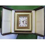 A Gucci desk clock, the rectangular brass and cream enamel frame enclosing a white dial, Eight Day