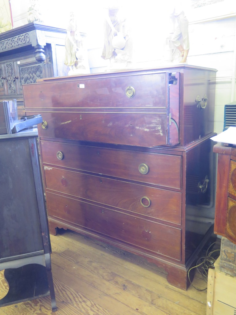 A George III mahogany secretaire chest, the top secretaire section with brass carry handles, fall