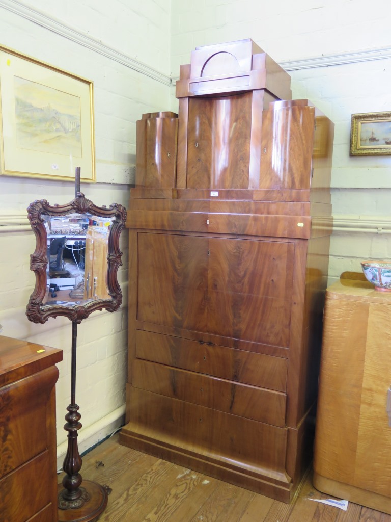 A 19th century Biedermeier flame mahogany secretaire a abattant, the superstructure with three