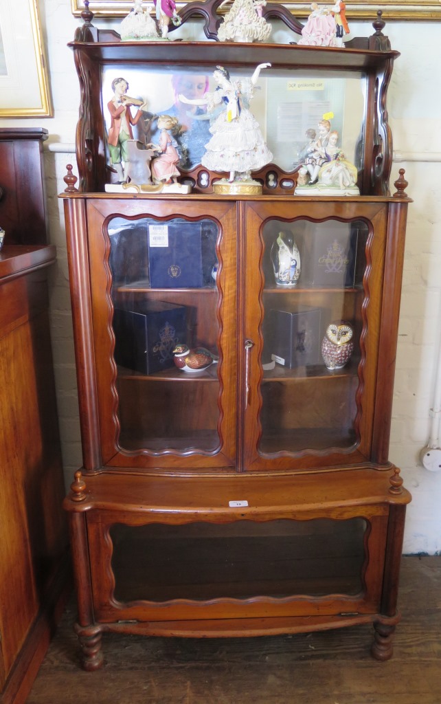 A mid Victorian walnut stepped side cabinet, the pierced top over a mirror back, glazed cupboard