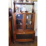 A mid Victorian walnut stepped side cabinet, the pierced top over a mirror back, glazed cupboard