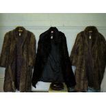 A black fur coat and two mink fur coats