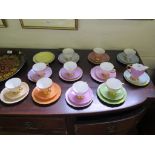 Ten Polychrome and gilt teacups, saucers and plates, a milk jug and additional saucers and plates